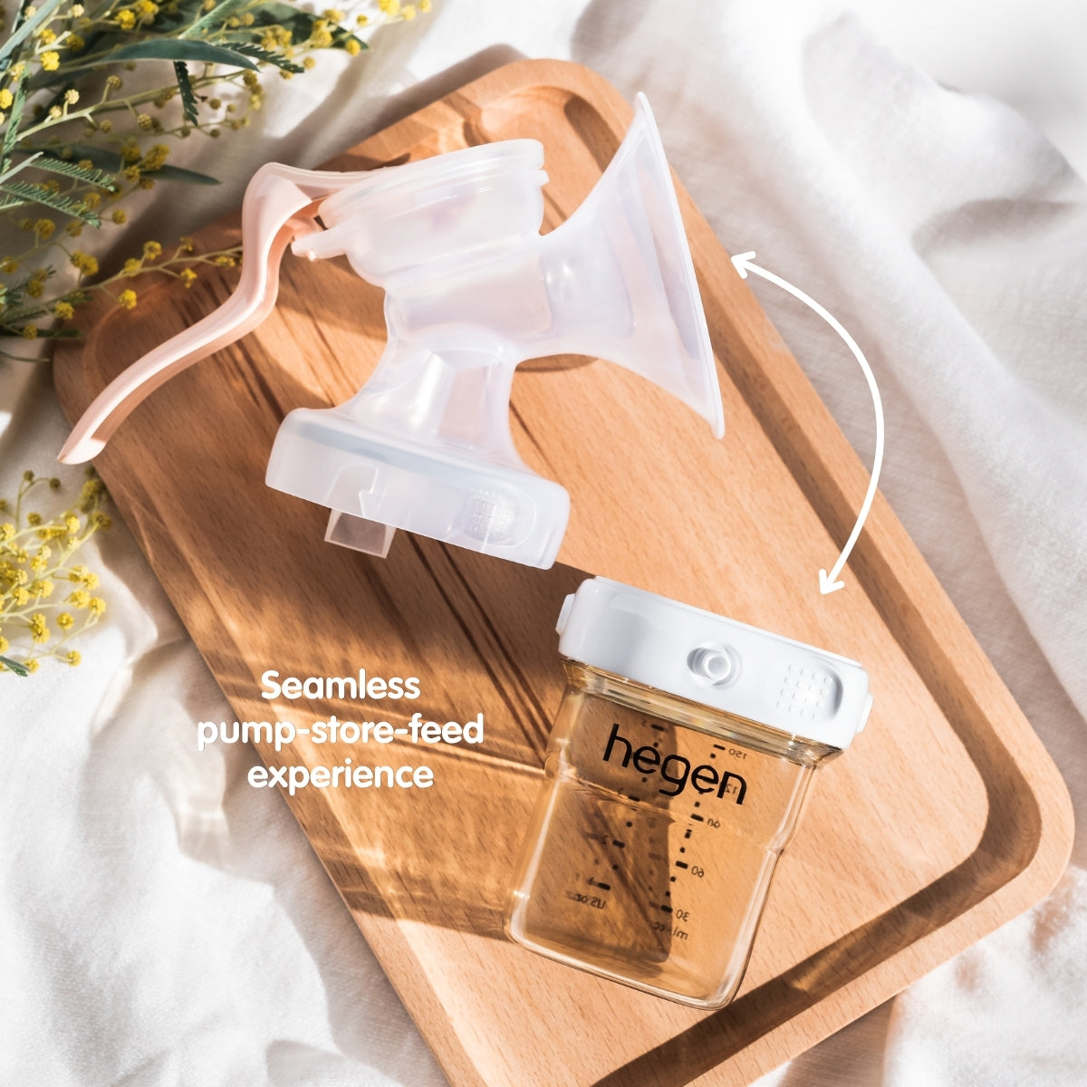 Hegen manual breast pump and 150ml bottle, with a white storage lid applied to the bottle.